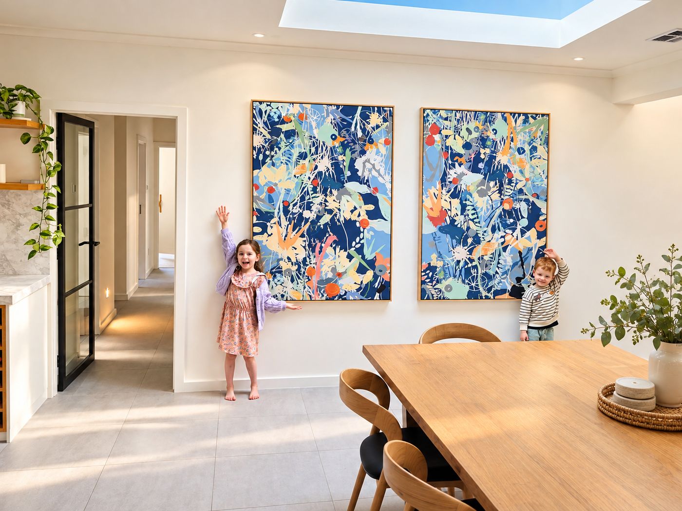 The same dining room with a pair of canvases designed from their paintings, the children standing beside them