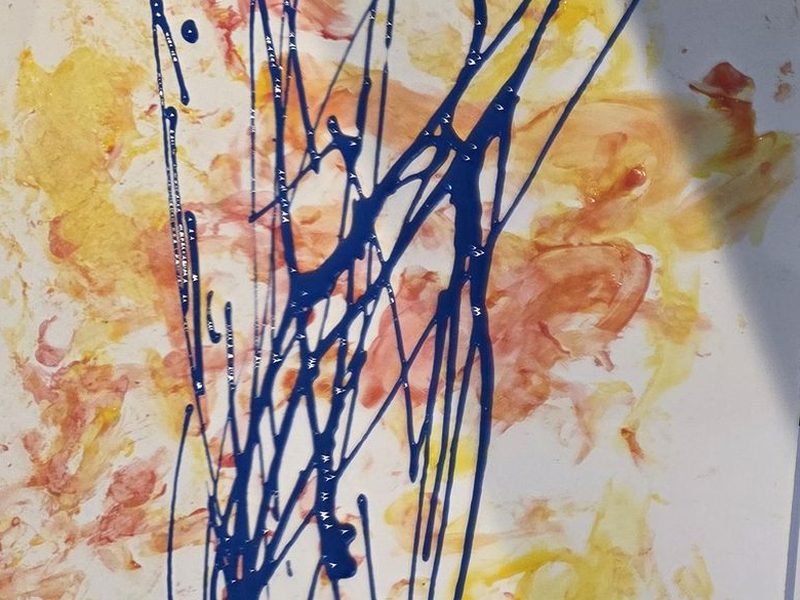 One of their child's finger paintings, in yellow, pink and blue