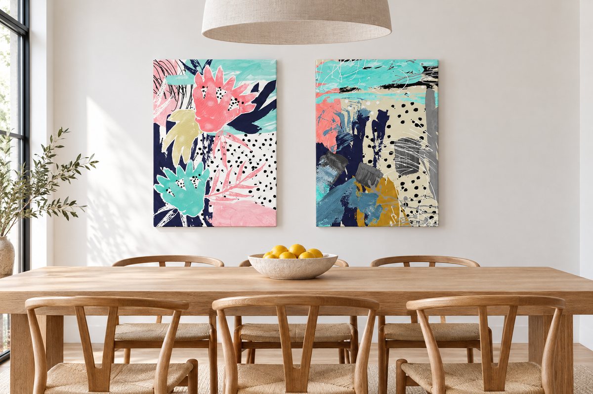 Two stretched canvases above an oak dining table
