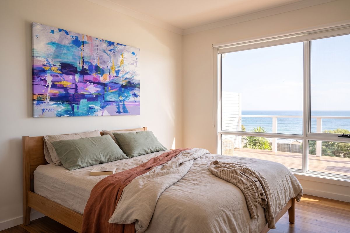 Coastal home, main bedroom, with a child's design on stretched canvas