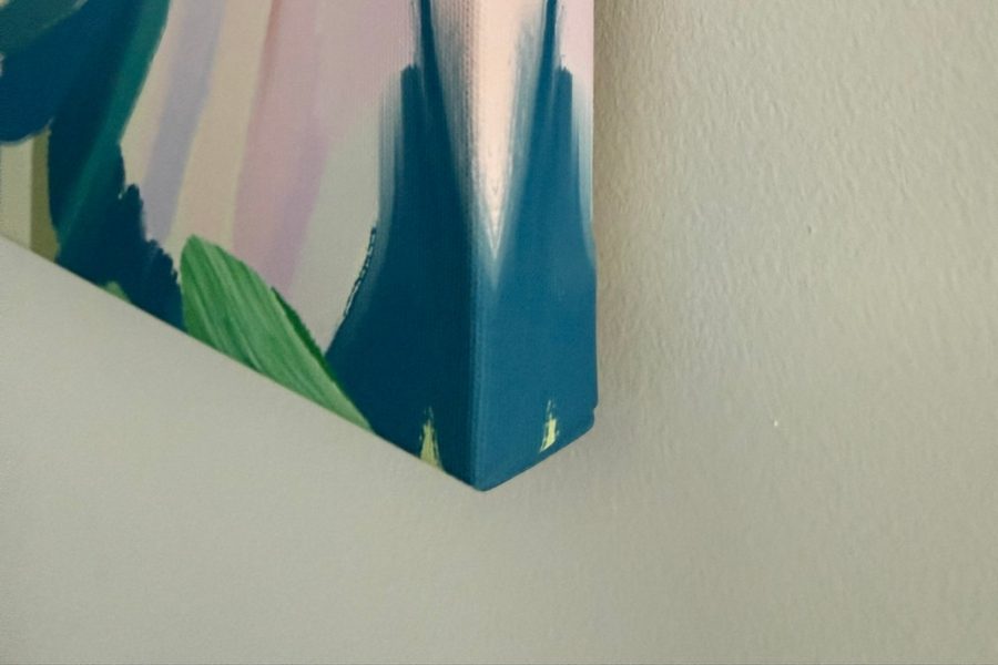 The deep wrapped edge of a canvas hanging on a wall