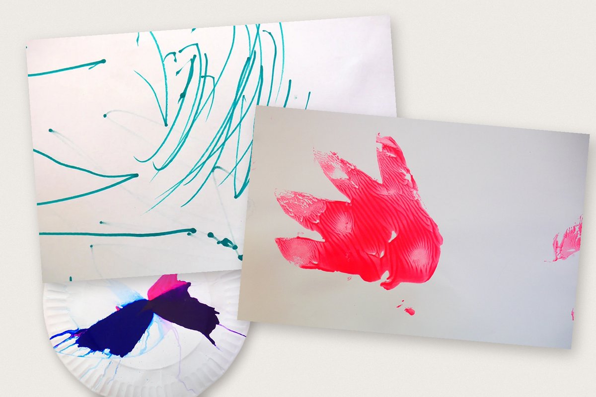 A child's paintings: teal scribbles, a pink hand print and a painted paper plate